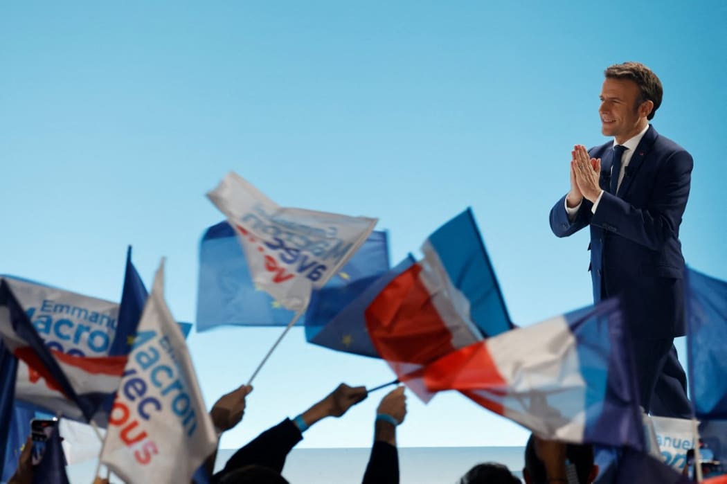 French President and La Republique en Marche (LREM) party candidate for re-election Emmanuel Macron gestures prior to addressing sympathizers after the first results of the first round of France's presidential election at the Paris Expo Porte de Versailles Hall 6 in Paris, on April 10, 2022.