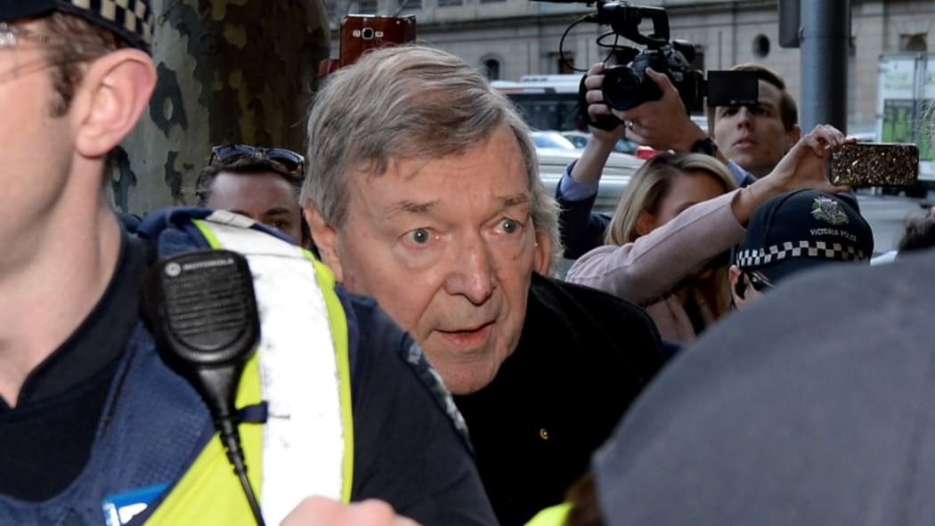 Cardinal George Pell arrives under heavy police protection for a filing hearing at the Melbourne Magistrates Court after being charged with sexual assault offences in Melbourne, July 26, 2017.