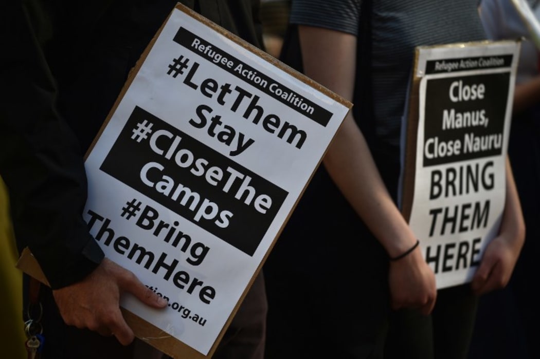 Refugee supporters hold placards as they gather in Sydney to mark the milestone of 200 days of continuous protests in the detention camp on the Pacific island of Nauru in 2016.