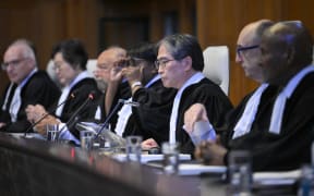 President of the International Court of Justice (ICJ) Yuji Iwasawa (C) and members issue first Advisory Opinion (AO) on States' legal obligations to address climate change, in The Hague on 23 July 2025.