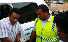 Mathew Batsiua being escorted into court