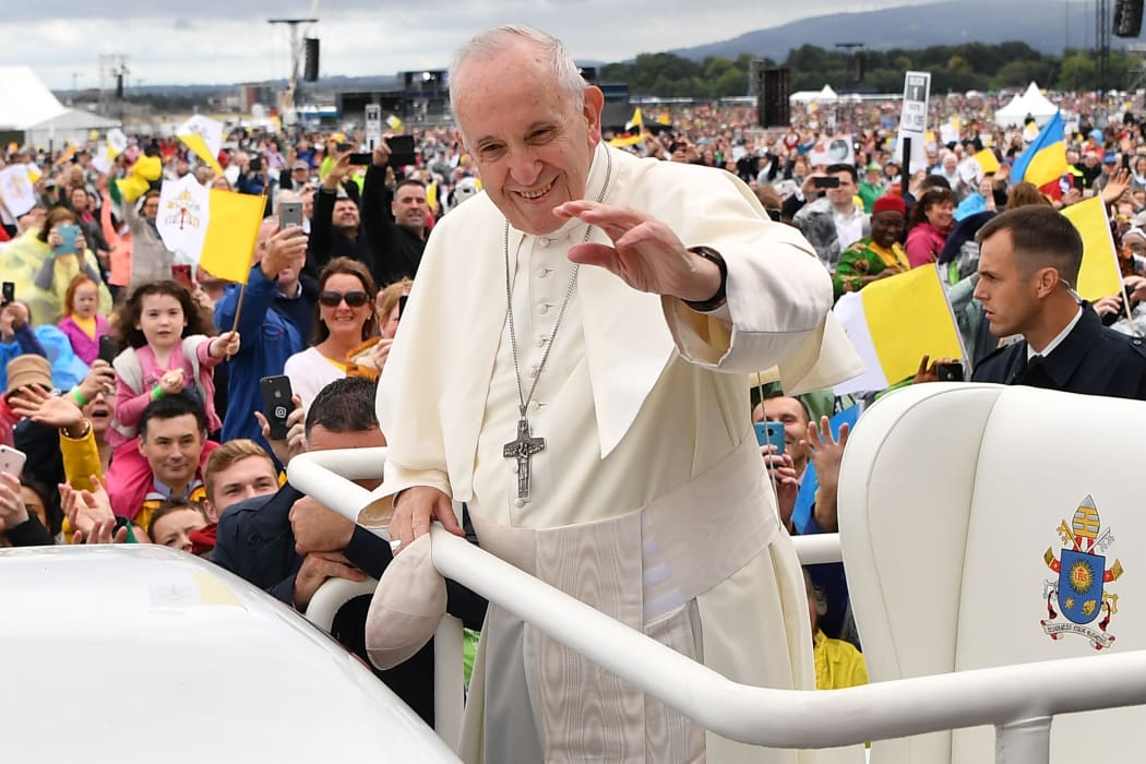 Pope Francis waves to the faithfull as he arrives to lead the Holy Mass at Phoenix Park in Dublin.