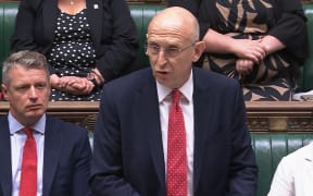 A video grab from footage broadcast by the UK Parliament's Parliamentary Recording Unit (PRU) Britain's Defence Secretary John Healey making a statement to MPs on the  in the House of Commons in London on July 15, 2025, following the lifting on reporting restrictions relating to the relocation of Afghans who worked with the UK government, as a result of huge data breach in 2022. Thousands of Afghans who worked with the UK government were brought to Britain in a secret relocation programme after a huge 2022 data breach, a minister revealed Tuesday. Defence Minister John Healey told parliament about the scheme after the UK High Court lifted an order banning media from reporting that the names and details of almost 19,000 Afghans asking for asylum had been accidentally leaked just months after the Taliban seized Kabul. (Photo by PRU / AFP) / RESTRICTED TO EDITORIAL USE - MANDATORY CREDIT "AFP PHOTO / PRU " - NO MARKETING - NO ADVERTISING CAMPAIGNS - DISTRIBUTED AS A SERVICE TO CLIENTS
