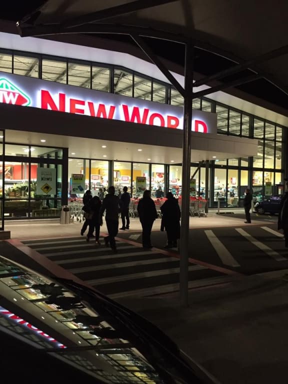 Shoppers gather outside Howick New World after being evacuated.
