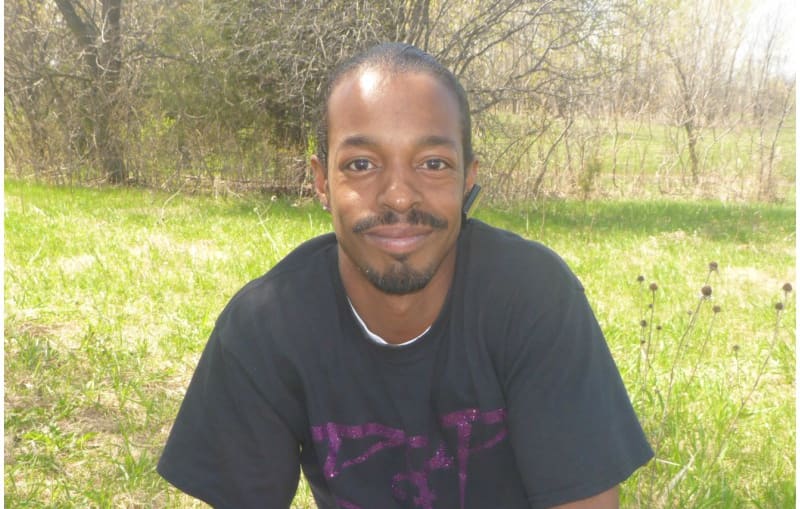 Aaron, a life long fan from St Paul (twin city to Minneapolis) outside Paisley Park on the first anniversary of Prince's death.