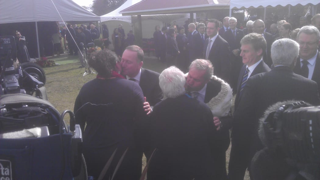 Prime Minister John Key, left, is greeted along with other National Party members.