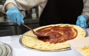 Pizza, fast food worker in kitchen, takeaway.