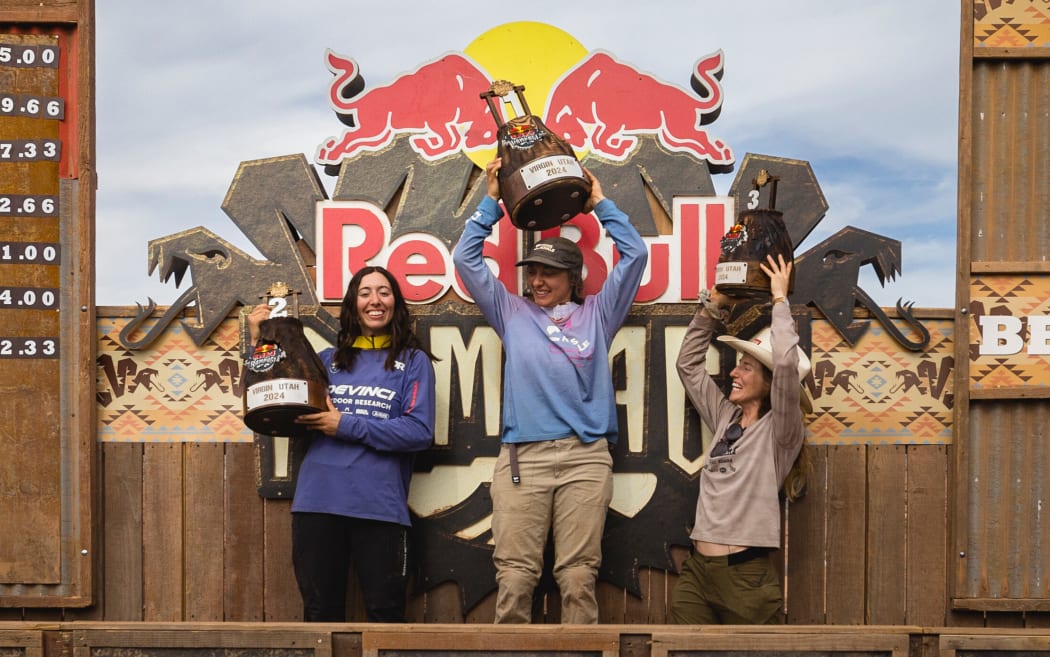 Georgia Astle, Robin Goomes, Casey Brown celebrate at Red Bull Rampage in Virgin, Utah.