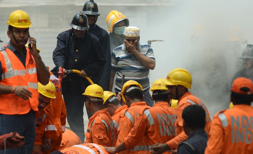 A 117-year-old condemned building has collapsed in the Indian city of Mumbai after torrential rains this week, killing at least 22 people, with about 10 others feared trapped, police and fire officials say.