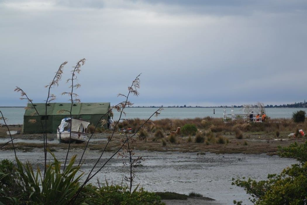 Forensics and police investigators examine the scene where John Murray Morton's body was found in Nelson Haven beside SH6 in Atawhai.