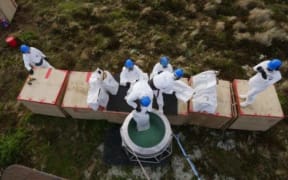 Loading a bait hopper.