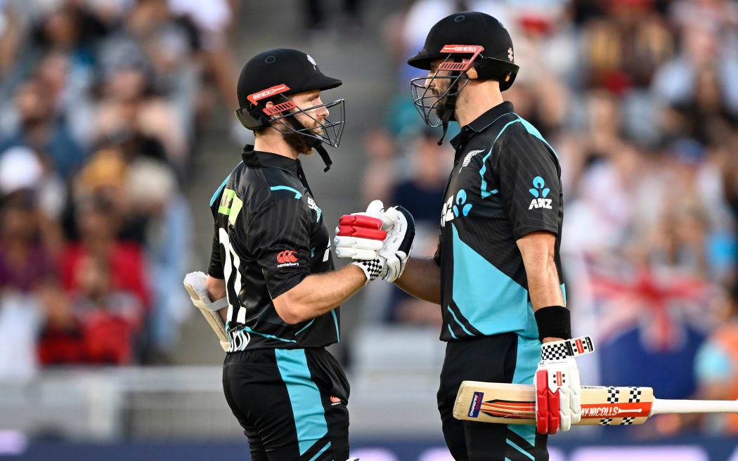 New Zealand captain Kane Williamson celebrates his 50 runs with Daryl Mitchell.