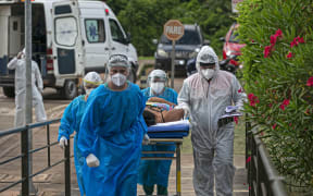 A Covid-19 patient is transferred from the Emergency Care Unit of Santarem, Para state, Brazil, to another hospital of Para, on February 7, 2021.