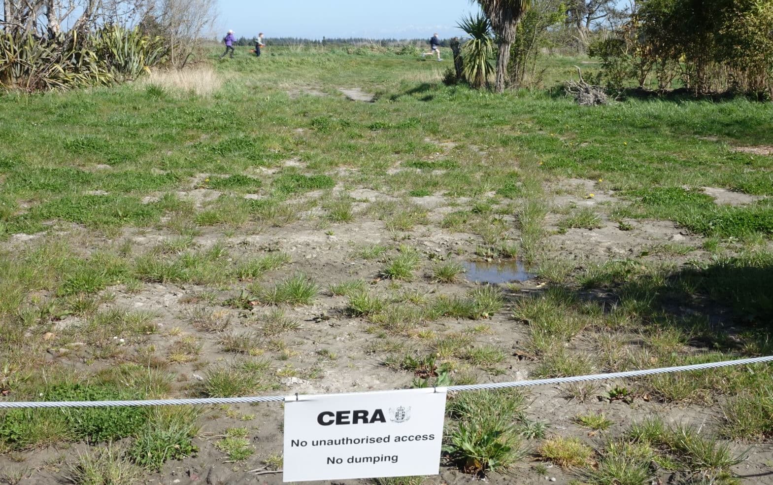 Children dash through a red zone property in Kairaki, north of Christchurch.