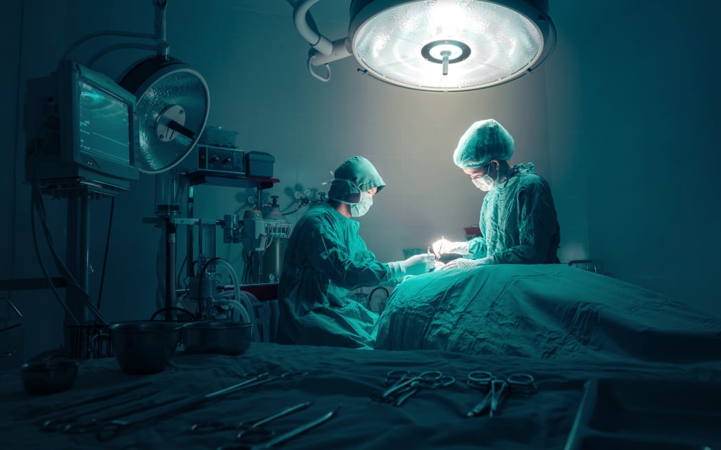 Surgeons team working with Monitoring of patient in surgical operating room.