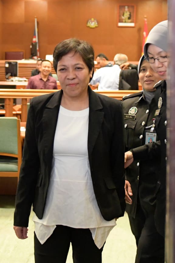 Maria Elvira Pinto Exposto is escorted from the High Court after being cleared of drug trafficking charges in Shah Alam, outside Kuala Lumpur.