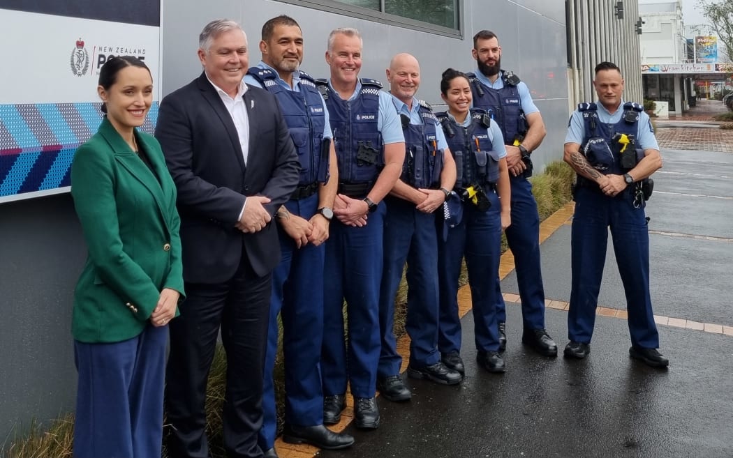 Rotorua Mayor Tania Tapsell, Police Minister Mark Mitchell, area commander Inspector Herby Ngawhika, Bay of Plenty District Commander Superintendent Tim Anderson, Senior Community Constable, Tony O’Keeffe (far right) along with other local officers at Rotorua police station.