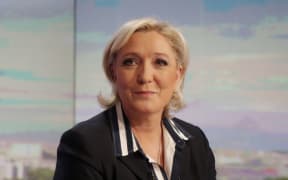French presidential election candidate for the far-right Front National (FN) party, Marine Le Pen poses prior to an interview on the prime time evening news broadcast of French private television channel TF1, on May 2, 2017 in Boulogne-Billancourt, near Paris