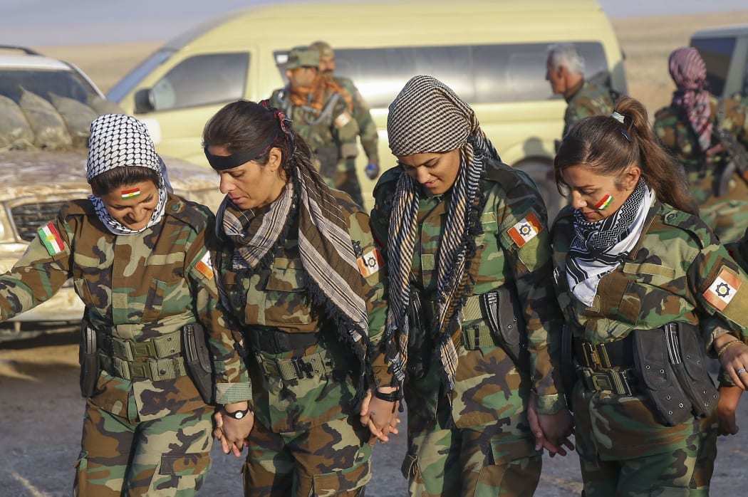 Iraqi Kurdish Regional Government's peshmerga forces perform traditional dances before they start to attack Daesh targets