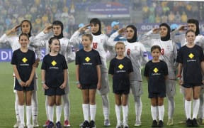 Iran's players salute during the national anthem before the AFC Women's Asian Cup match against Australia.