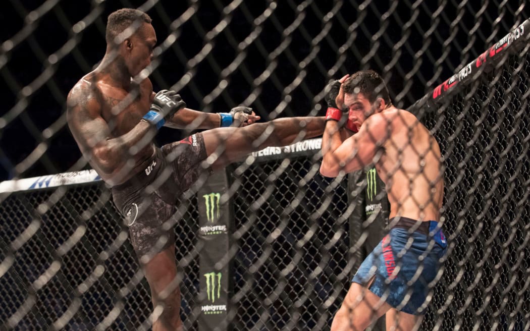 Adesanya goes for a head kick to Rob Wilkinson at UFC 221