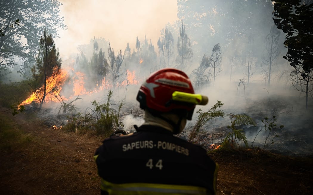 Smoke rises from a forest fire near Louchats, some 35km from Landiras in Gironde, southwestern France on 18 July 2022.