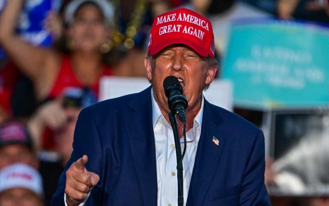 Former US President and Republican presidential candidate Donald Trump gestures as he speaks during a rally in Doral, Florida, on July 9, 2024. (Photo by Giorgio Viera / AFP)