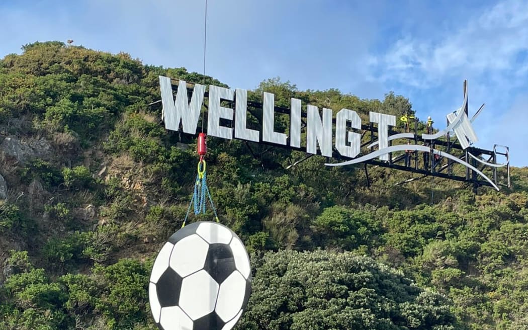 A crane was used to put the giant football in place on the Wellington sign.