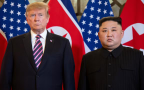 (FILES) In this file photo taken on February 27, 2019 US President Donald Trump (L) and North Korea's leader Kim Jong Un pose before a meeting at the Sofitel Legend Metropole hotel in Hanoi. -