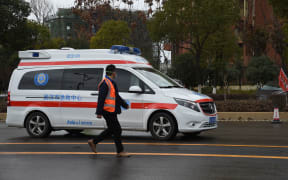 An ambulance carrying coronavirus patients arrives at a hospital in Wuhan, Feb 8 2020.