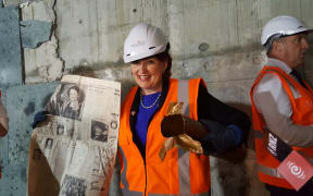Minister of Arts, Culture and Heritage Maggie Barry officially opens a time capsule from the 1960s, found near the Beehive in Wellington.