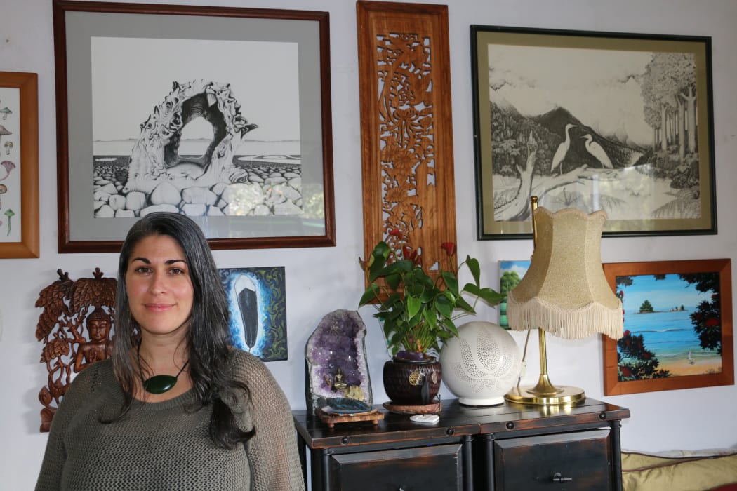 Huia Hamon at her home in Waitakere, art in the background is by her grandfather Rei Hamon.