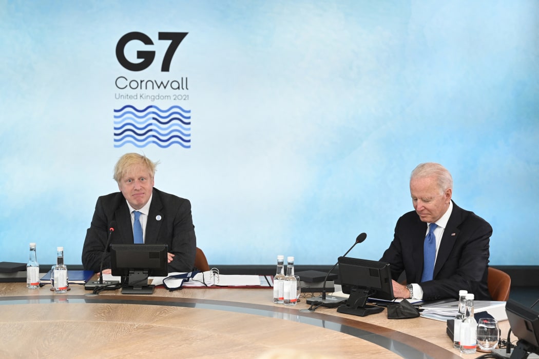 Britain's Prime Minister Boris Johnson (L) and US President Joe Biden sit around the table at the start of the G7 summit in Carbis Bay, Cornwall on 11 June 2021.