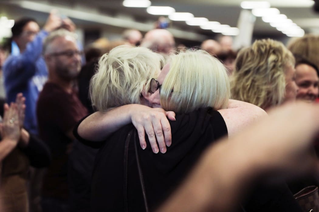 A passenger is reunited with loved ones after the first quarantine-free Wellington flight from Auckland disembarks.