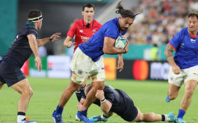 Samoa flanker Chris Vui tries to break Scotlish defence.