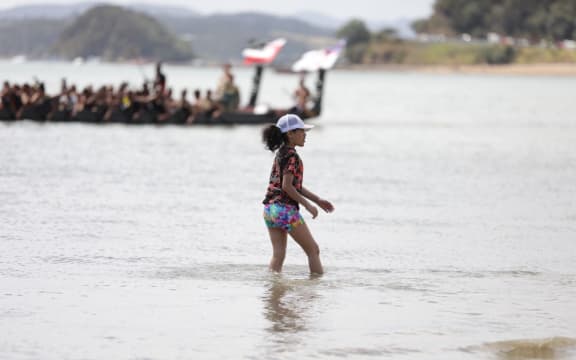 A girl walking in the water.