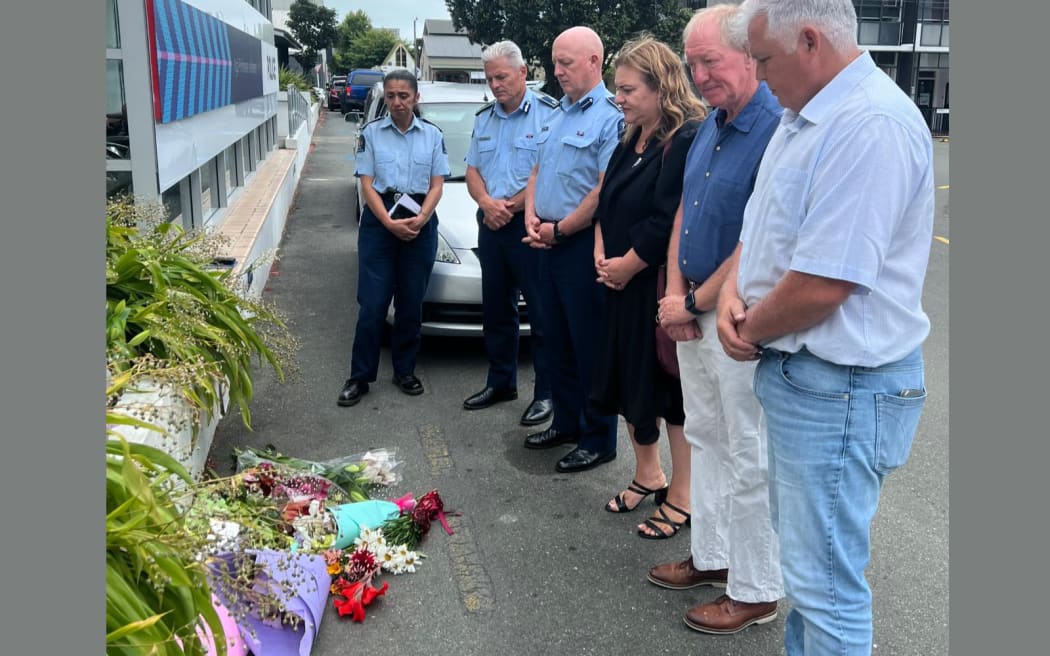 Nelson Mayor Nick Smith, second from right, Police Minister Hon Mark Mitchell, right, MP Rachel Boyack, centre, Commissioner Richard Chambers, second from left, Mike Johnston and Tracey Thompson pay tribute in Nelson to Senior Sgt. Lyn Fleming.