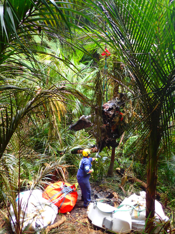 Investigators remove the wreckage of a Robinson R44 helicopter in Glenbervie forest near Whangarei.