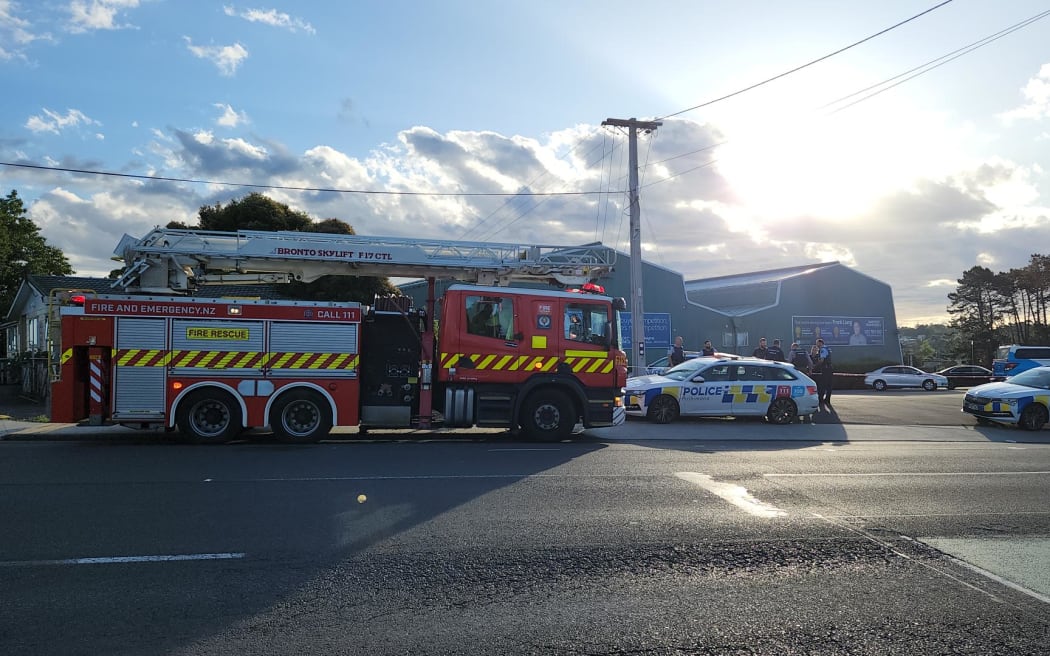 Police at a walkway beside a Massey, West Auckland, badminton centre after what they are calling a sudden death.
