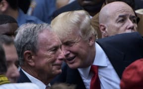 (FILES) In this file photo taken on September 11, 2016 US Republican presidential nominee Donald Trump speaks to former New York City Mayor Michael Bloomberg  during a memorial service at the National 9/11 Memorial in New York.