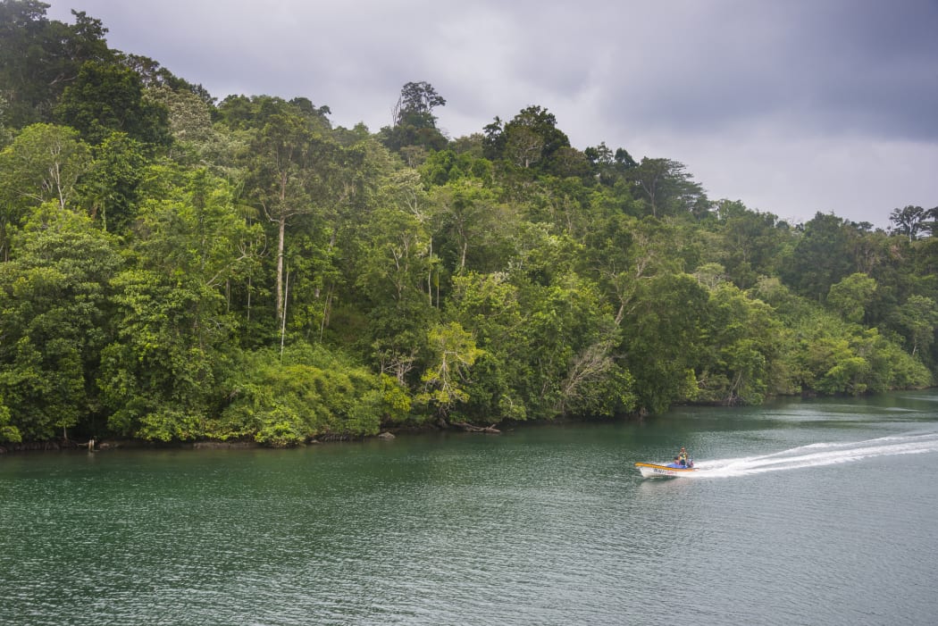 A boat on a river in the jungle of Manus Island