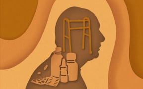 Cut paper silhouette of elderly person, walker, and medicine