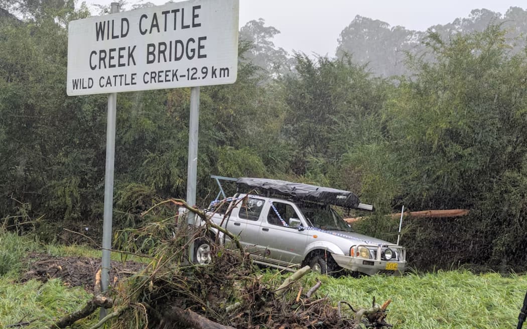 Local Tom Cook drove his ute onto the flooded Wild Cattle Creek Bridge on Friday.