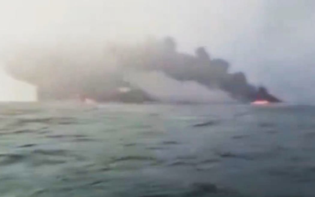 A screeshot of video showing smoke billowing as a cargo ship smashed into a US-flagged oil tanker carrying jet fuel off the northeast coast of England.