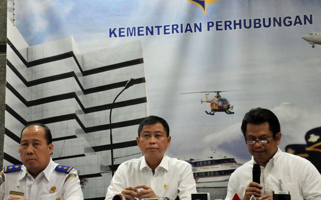 Indonesia's Transport Minister Ignasius Jonan (C) speaks during a press conference in Jakarta.