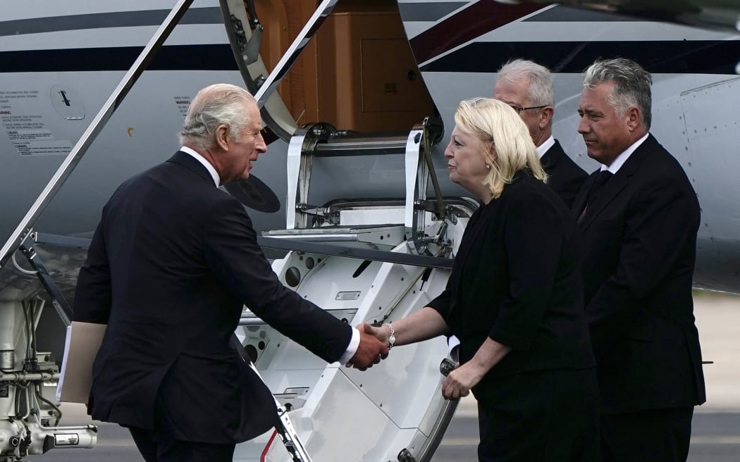 King Charles III (L) is greeted as he prepares to board his plane at Aberdeen Airport to travel to London, a day after the death of his mother, Queen Elizabeth II.