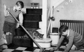 Young children completing household tasks