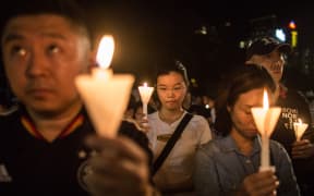 People hold a vigil in Hong Kong on June 4 to mark the 27th anniversary of the bloody Tiananmen Square crackdown.