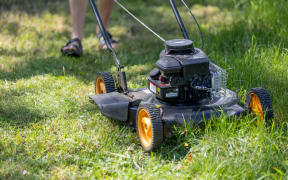 A man mowing a lawn.