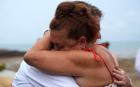 Survivors of Cyclone Tracy who lost loved ones to the natural disaster embraced one another during the event.